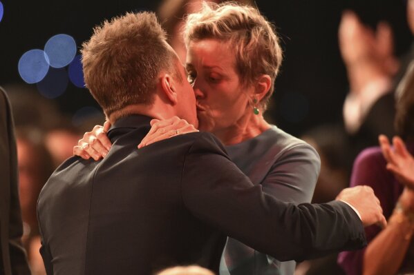 
              Frances McDormand, right, congratulates Sam Rockwell in the audience after he won the award for outstanding performance by a male actor in a supporting role for "Three Billboards Outside Ebbing, Missouri" at the 24th annual Screen Actors Guild Awards at the Shrine Auditorium & Expo Hall on Sunday, Jan. 21, 2018, in Los Angeles. (Photo by Vince Bucci/Invision/AP)
            