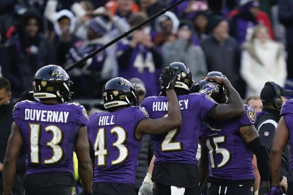 Baltimore Ravens players celebrate a touchdown by Baltimore Ravens quarterback Tyler Huntley (2) in the final minute of an NFL football game against the Denver Broncos, Sunday, Dec. 4, 2022, in Baltimore. (AP Photo/Patrick Semansky)