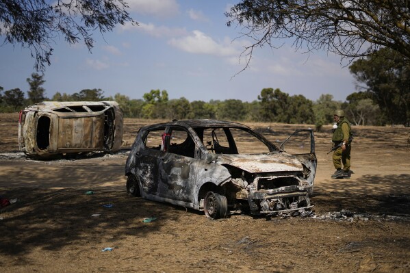 FILE - Israeli soldiers inspect the site of a music festival near the border with the Gaza Strip in southern Israel, Friday. Oct. 13, 2023. Body camera footage has emerged, Saturday, Nov. 4, showing Israeli security forces searching for survivors in the aftermath of the bloody Hamas rampage through an outdoor music concert in southern Israel. (AP Photo/Ariel Schalit, File)