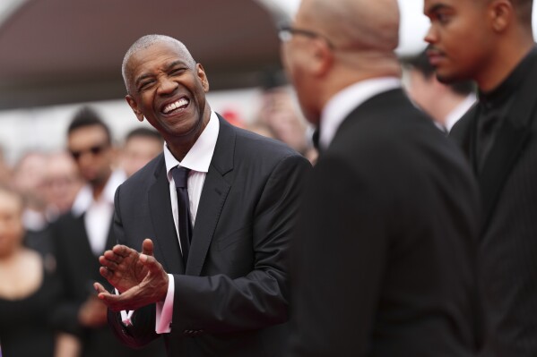Denzel Washington, left, poses for photographers upon arrival at the premiere of the film 'Highest 2 Lowest' at the 78th international film festival, Cannes, southern France, Monday, May 19, 2025. (Photo by Scott A Garfitt/Invision/AP)
