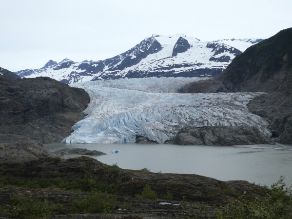 The Mendenhall Glacier, glimpsed from along the West Glacier trail, on June 8, 2023, in Juneau, Alaska. (AP Photo/Becky Bohrer)