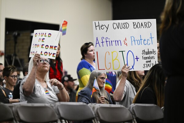 Parents, students, and staff of Chino Valley Unified School District hold up signs in favor of protecting LGBTQ+ policies at Don Antonio Lugo High School, on Thursday, June 15, 2023. California's attorney general has sued a Southern California school district over its new policy that requires schools to notify parents if their children change their gender identification or pronouns. Attorney General Rob Bonta announced the suit Monday, Aug. 28, against Chino Valley Unified School District. (Photo by Anjali Sharif-Paul/The Orange County Register via AP)