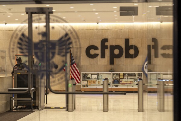 A security officer works inside of the Consumer Financial Protection Bureau (CFPB) building headquarters Monday, Feb. 10, 2025, in Washington. (AP Photo/Jacquelyn Martin, File)