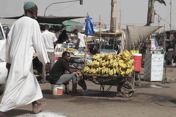 FILE - A man sells bananas at a market during a cease-fire in Khartoum, Sudan, Saturday, May 27, 2023. Two U.N. agencies are warning of rising food emergencies including starvation in Sudan due to the outbreak of war and in Haiti, Burkina Faso and Mali due to restricted movements of people and goods. The four countries join Afghanistan, Nigeria, Somalia, South Sudan and Yemen at the highest alert levels. (AP Photo/Marwan Ali, File)