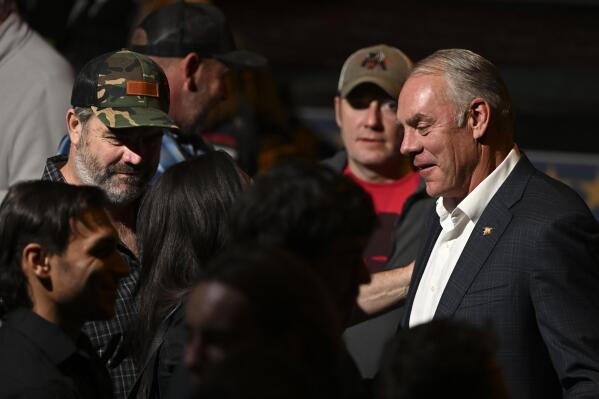 Former Interior Secretary Ryan Zinke, Republican candidate in Montana's 1st Congressional District, talks with people at an election-night watch party in Whitefish, Mont., Tuesday, Nov. 8, 2022. (AP Photo/Tommy Martino)
