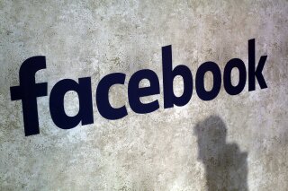 FILE - This Jan. 17, 2017, file photo shows a Facebook logo at Station F in Paris. Facebook has decided not to limit how political ads can be targeted to specific groups of people, as its main digital-ad rival Google did in November 2019 to fight misinformation. Neither will it ban political ads outright, as Twitter has done. And it still won't fact check them, as it's faced pressure to do. (AP Photo/Thibault Camus, File)