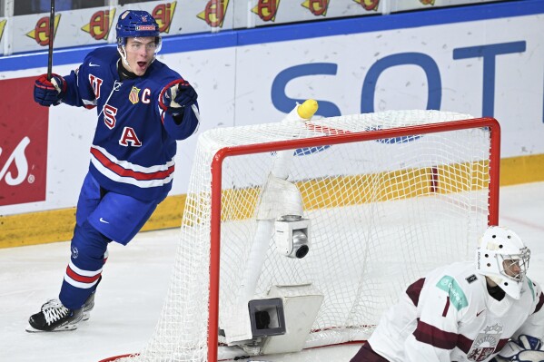 USA's Rutger McGroarty celebrates scoring during the IIHF World Junior Championship ice hockey quarterfinal match between USA and Latvia at Frolundaborg in Gothenburg, Sweden, Tuesday Jan. 2, 2024. (Bjorn Larsson Rosvall/TT via AP)