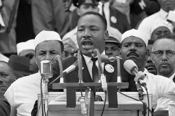 FILE - Dr. Martin Luther King Jr. addresses marchers during his 