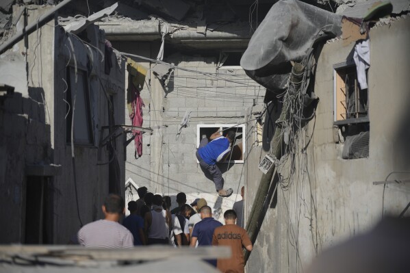 Palestinians look for survivors after an Israeli strike in the Nusseirat refugee camp in the Gaza Strip on Saturday, Nov. 4, 2023. (AP Photo/Hatem Moussa)