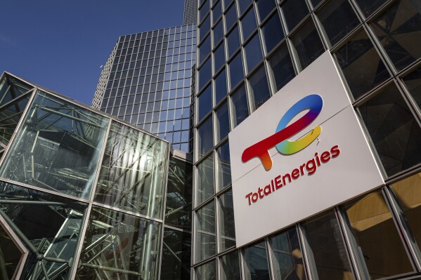 The logo of TotalEnergies is seen at the company's headquarters skyscraper in the La Defense business district in Courbevoie near Paris, France, Wednesday, March 1, 2023. Environmental group Greenpeace released a video Wednesday Aug. 30, 2023 ahead of the rugby World Cup showing a massive amount of oil flooding the Stade de France in a campaign against fossil fuel sponsorship of big sporting events. (AP Photo/Aurelien Morissard)