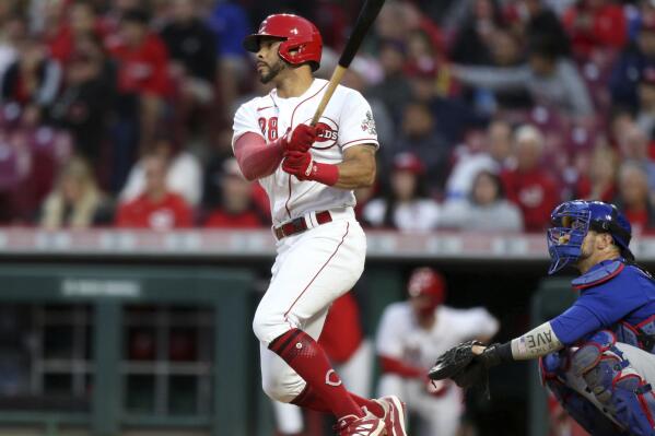 Cincinnati Reds' Tommy Pham, left, watches his home run in front of Chicago Cubs catcher Yan Gomes during the sixth inning of a baseball game in Cincinnati, Monday, May 23, 2022. (AP Photo/Paul Vernon)