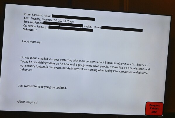 An email from Oxford High School teacher Allison Karpinski concerning Ethan Crumbley is displayed during the trial of James Crumbley, father of Ethan, in the Oakland County Courtroom on Monday, March 11, 2024, in Pontiac, Mich. Crumbley is on trial for involuntary manslaughter in his 15-year-old son's killing of four students at Oxford High School. (Daniel Mears/Detroit News via AP, Pool)