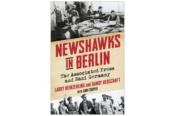 This cover image released by Columbia University Press shows "Newshawks in Berlin: The Associated Press and Nazi Germany" by Larry Heinzerling and Randy Herschaft, with Ann Cooper. (Columbia University Press via AP)