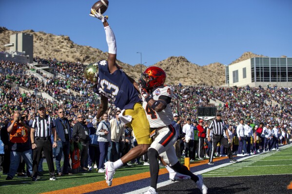 Notre Dame wide receiver Jayden Thomas (83) fails to catch a touchdown pass as he's defended by Oregon State defensive back Jaden Robinson (4) during the first half of the Sun Bowl NCAA college football game, Friday, Dec. 29, 2023, in El Paso, Texas. (AP Photo/Andres Leighton)