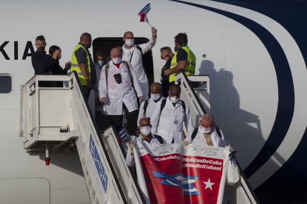 Cuban doctors arrive at the Jose Marti International Airport in Havana, Cuba, June 8, 2020, after traveling to Italy to help with the COVID-19 emergency response. (Ismael Francisco/Pool via AP, File)