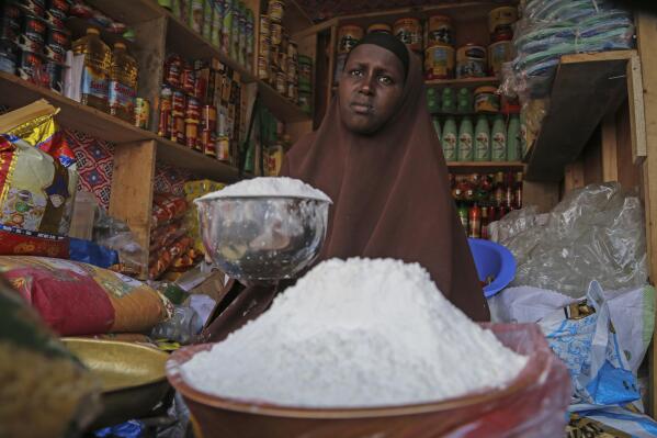 FILE - A shopkeeper sells wheat flour in the Hamar-Weyne market in the capital Mogadishu, Somalia on May 26, 2022. "Africa is actually taken hostage" in Russia's invasion of Ukraine amid catastrophically rising food prices, Ukrainian President Volodymyr Zelenskyy told the African Union during a closed-door address on Monday, June 20, 2022. (AP Photo/Farah Abdi Warsameh, File)
