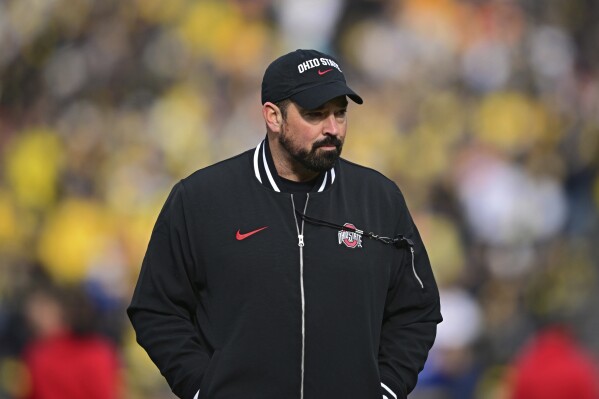 Ohio State head coach Ryan Day walks before a NCAA college football game against Michigan, Saturday, Nov. 25, 2023, in Ann Arbor, Michigan. (AP Photo/David Dermer)