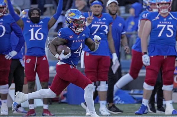 Kansas running back Devin Neal (4) runs for a first down during the second half of an NCAA college football game against Oklahoma State Saturday, Nov. 5, 2022, in Lawrence, Kan. Kansas won 37-16. (AP Photo/Charlie Riedel)