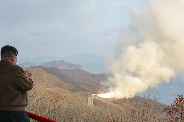 In this photo provided by the North Korean government, North Korean leader Kim Jong Un, left, watches what it says a test of a solid-fuel engine for its new-type intermediate-range hypersonic missile at the Sohae Satellite Launching Ground in North Korea Tuesday, March 19, 2024. Independent journalists were not given access to cover the event depicted in this image distributed by the North Korean government. The content of this image is as provided and cannot be independently verified. (Korean Central News Agency/Korea News Service via AP)