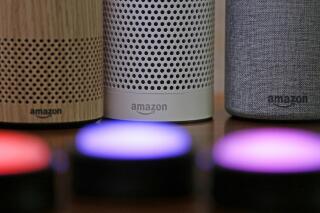 FILE - Amazon Echo and Echo Plus devices, behind, sit near illuminated Echo Button devices during an event by the company in Seattle on Sept. 27, 2017. Amazon’s Alexa might soon replicate the voice of family members - even if they’re dead. The capability, unveiled at Amazon’s Re:Mars conference in Las Vegas Wednesday, June 22, 2022, is in development and would allow the virtual assistant to mimic the voice of a specific person based on a less than a minute of provided recording. (AP Photo/Elaine Thompson, File)