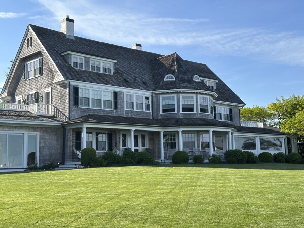 A home sits on a freshly mowed lawn in Edgartown, Mass., Tuesday, June 4, 2024. High housing costs on Martha's Vineyard are forcing many regular workers to leave and are threatening public safety. (AP Photo/Nick Perry)