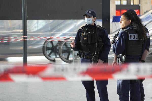 Police officers patrol at the Gare du Nord train station, Wednesday, Jan. 11, 2023 in Paris. A knife attacker wounded six people in an unprovoked attack in Paris' busy Gare du Nord train station Wednesday morning before being shot by police, the French interior minister said. (AP Photo/Michel Euler)