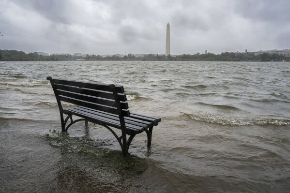 FILE - The Tidal Basin in Washington overflows the banks with rain from Tropical Storm Ophelia on Sept. 23, 2023. (AP Photo/J. David Ake, File)