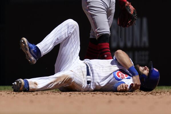 Chicago Cubs' David Bote reacts after an injury during the fourth inning of a baseball game against the Cincinnati Reds in Chicago, Saturday, May 29, 2021. (AP Photo/Nam Y. Huh)