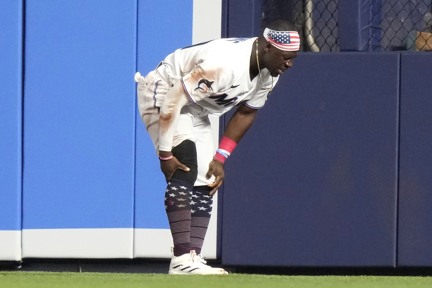 Marlins center fielder Davis is carted off the field with bruised