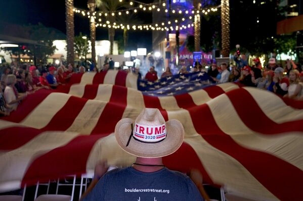 President Donald Trump supporters wave a flag during an election watch party Tuesday, Nov. 3, 2020, in Chandler, Ariz. (AP Photo/Matt York)