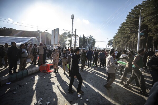People are seen after an explosion in Kerman, Iran, Wednesday, Jan. 3, 2024. Explosions at an event honoring a prominent Iranian general slain in a U.S. airstrike in 2020 have killed at least 73 people and wounded over 170 others, state-run media in Iran reported Wednesday. (AP Photo/Mahdi Karbakhsh Ravari)