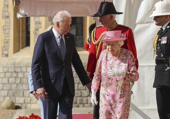 Britain's Queen Elizabeth II, right, walks with US President Joe Biden during his visit to Windsor Castle, near London, Sunday June 13, 2021. (Chris Jackson/Pool Photo via AP)