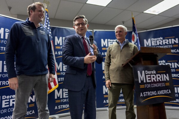 Speaker of the House Mike Johnson, R-La., center, joined by Rep. Bob Latta, R-Ohio, right, and Ohio state Rep. Derek Merrin, speaks during a campaign event at the Lucas County Republican Party headquarters in Holland, Ohio, Saturday, Oct. 26, 2024. (AP Photo/Carolyn Kaster)