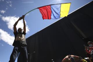 A man waves a banner representing Colombia's national colors during an anti-government protest triggered by proposed tax increases on public services, fuel, wages and pensions in Bogota, Colombia, Wednesday, June 2, 2021. (AP Photo/Fernando Vergara)