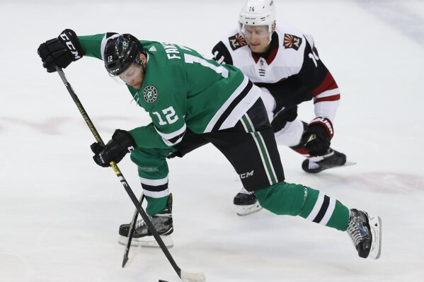 
              Dallas Stars center Radek Faksa (12) skates for the puck against Arizona Coyotes right wing Richard Panik (14) during the first period of an NHL hockey game in Dallas, Monday, Feb. 4, 2019. (AP Photo/LM Otero)
            