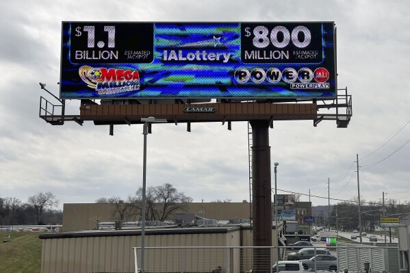 An electronic billboard advertises the Mega Millions and Powerball jackpots, Monday, March 25, 2024, in in Des Moines, Iowa, that when combined amount to nearly $2 billion. It's the first time the two lottery games each have jackpots of $800 million or more. (AP Photo/Scott McFetridge)