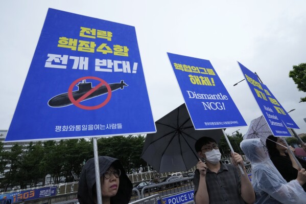 Protesters stage a rally against a meeting of Nuclear Consultative Group between South Korea and the United States in front of the presidential office in Seoul, South Korea, Tuesday, July 18, 2023. A bilateral consulting group of South Korean and U.S. officials met Tuesday in Seoul to discuss strengthening their nations' deterrence capabilities against North Korea's evolving nuclear threats. The signs read 