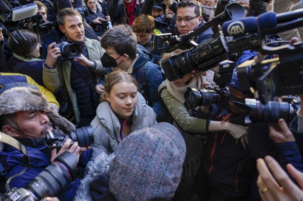 Climate activist Greta Thumberg, center, arrives at the Westminster Magistrates Court, in London, Wednesday, Nov. 15, 2023, where she has to appear, following her charges with a public order offence after she was arrested while taking part in a protest against a conference in London described as "the Oscars of oil". (AP Photo/Alberto Pezzali)