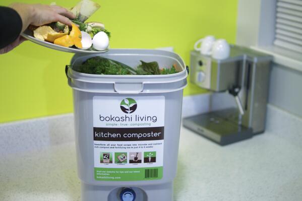 This image provided by Bokashi Living shows kitchen scraps being added to a bokashi composting bucket. (bokashiliving.com via AP)