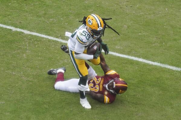 Green Bay Packers linebacker De'Vondre Campbell (59), intercepts a pass intended for Washington Commanders running back J.D. McKissic (23) during the first half of an NFL football game, Sunday, Oct. 23, 2022, in Landover, Md. Campbell ran the interception for a touchdown on the play. (AP Photo/Al Drago)