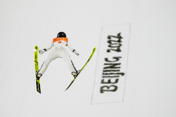Ursa Bogataj, of Slovenia, soars through the air during the mixed team trial round at the 2022 Winter Olympics, Monday, Feb. 7, 2022, in Zhangjiakou, China. (AP Photo/Matthias Schrader)