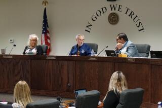 FILE - From left, Nye County Commissioners Debra Strickland, Frank Carbone and Leo Blundo discuss appointing a new county clerk on July 19, 2022, in Pahrump, Nev. The rural Nevada county filed a response to a lawsuit brought on by the ACLU's Nevada Chapter, asking the court to bar the county's controversial hand-counting process. (AP Photo/Samuel Metz, File)