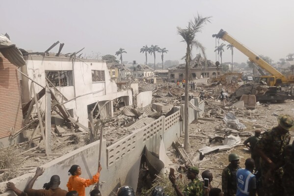 People gather at the site of an explosion in Ibadan, Nigeria, Wednesday, Jan. 17, 2024. Several people died and many others were injured after a massive blast caused by explosives rocked more than 20 buildings in one of Nigeria's largest cities Tuesday night, authorities said Wednesday, as rescue workers dug through the rubble in search of those feared trapped. (AP Photo)