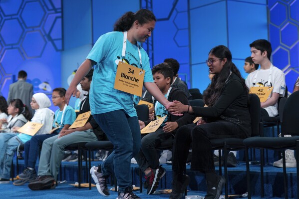 Blanche Yang Lee, 14, of Boulder, Colorado, fishes her friends after correctly spelling her words out in the first spare round of Scripps National Spelling Bee at Gaylord National Resort & Convention Center in Oxon Hill, Maryland on Tuesday, May 27, 2025.
