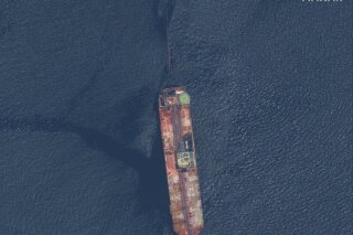 This satellite image released by Maxar Technologies shows the FSO Nabarima oil tanker off the coast of Trinidad and Tobago, Sunday, Aug. 9, 2020. The oil tanker listing off a remote Venezuelan coastline is triggering international calls for action. Critics of President Nicolas Maduro and maritime experts say the FSO Nabarima is taking on water and could sink. (Maxar Technologies via AP)