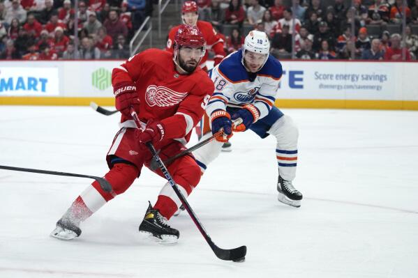 Edmonton Oilers left wing Zach Hyman (18) defends Detroit Red Wings defenseman Jake Walman (96) in the first period of an NHL hockey game Tuesday, Feb. 7, 2023, in Detroit. (AP Photo/Paul Sancya)