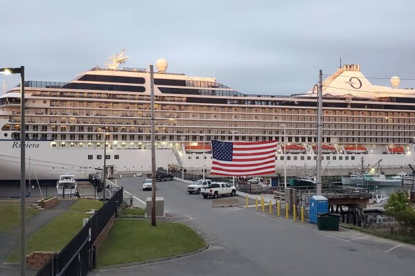 In this Monday, June 15, 2020 photo, the cruise ship Oceania Riviera is tied up in Eastport, Maine. Cruise lines stopped sailing in mid-March after several high-profile outbreaks of COVID-19 in ships at sea, and thousands of cruise ship workers are still stuck at sea. The Riviera arrived Sunday in Eastport for an indefinite stay. (Chris Gardner/Port of Eastport, via AP)
