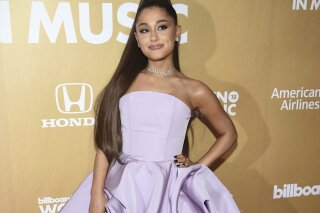 
              FILE - In this Dec. 6, 2018 file photo, Ariana Grande attends the 13th annual Billboard Women in Music event in New York. Grammys producer Ken Ehrlich says the show had multiple conversations with Grande about performing at the awards show on Sunday but the singer “felt it was too late for her to pull something together.” (Photo by Evan Agostini/Invision/AP, File)
            