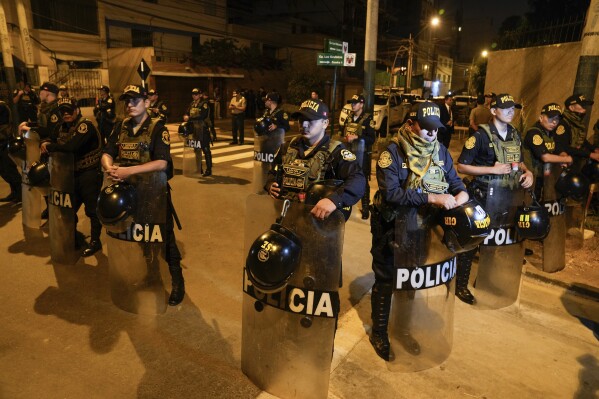 Police guard outside President Dina Boluarte's house during a raid ordered by the Attorney General's Office aimed at seizing Rolex watches as part of a preliminary investigation into alleged illicit enrichment in Lima, Peru, Saturday, March 30, 2024. (AP Photo/Martin Mejia)