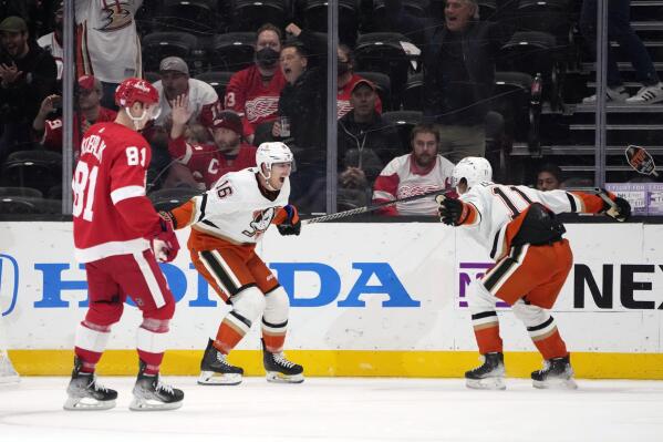 Anaheim Ducks center Ryan Strome (16) celebrate his overtime goal with center Trevor Zegras (11) as Detroit Red Wings left wing Dominik Kubalik (81) skates past, at the end of an NHL hockey game Tuesday, Nov. 15, 2022, in Anaheim, Calif. (AP Photo/Marcio Jose Sanchez)